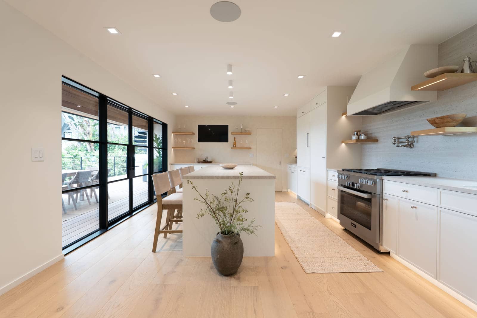 The Padaro Lane kitchen, steel doors open to the garden.